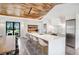 Contemporary kitchen featuring an island with seating, stainless steel appliances, and modern cabinetry at 3440 Crenshaw Lake Rd, Lutz, FL 33548