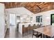 Open kitchen with modern white cabinets, stainless appliances and a large island at 3440 Crenshaw Lake Rd, Lutz, FL 33548
