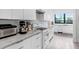 A bright modern kitchen features granite countertops, white cabinets, and stainless steel appliances at 3440 Crenshaw Lake Rd, Lutz, FL 33548