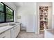 Bright kitchen area featuring a large window, white cabinets and stainless steel appliances at 3440 Crenshaw Lake Rd, Lutz, FL 33548