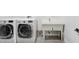 Clean laundry room featuring a sink and modern washer and dryer units at 3440 Crenshaw Lake Rd, Lutz, FL 33548