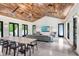 Elegant living room offering hardwood ceiling, dining space, and modern accents at 3440 Crenshaw Lake Rd, Lutz, FL 33548