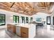 Open floor plan features wood ceiling, living room, dining area and kitchen island at 3440 Crenshaw Lake Rd, Lutz, FL 33548