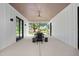 A covered patio with a table and bench seating offers a view of the outdoor space at 3440 Crenshaw Lake Rd, Lutz, FL 33548