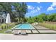 A pristine swimming pool, surrounded by lush landscaping, offers a relaxing outdoor retreat at 3440 Crenshaw Lake Rd, Lutz, FL 33548