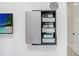 Interior shot featuring the gray Ergotron storage unit and a TV at 3440 Crenshaw Lake Rd, Lutz, FL 33548
