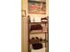 Bathroom storage unit near toilet with towels and decorative art at 3505 Tarpon Woods Blvd # P408, Palm Harbor, FL 34685