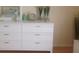 Bedroom showing white dresser with decor items, a mirror, and a view of the light colored flooring at 3505 Tarpon Woods Blvd # P408, Palm Harbor, FL 34685