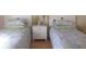 Bedroom featuring two twin beds, neutral decor, and plenty of space at 3505 Tarpon Woods Blvd # P408, Palm Harbor, FL 34685