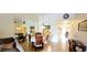 Dining area open to living room and kitchen, featuring a round table, mirrored wall and neutral decor at 3505 Tarpon Woods Blvd # P408, Palm Harbor, FL 34685