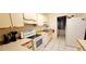Bright kitchen features white cabinetry, appliances, and tile flooring, offering a clean and functional space at 3505 Tarpon Woods Blvd # P408, Palm Harbor, FL 34685