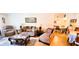 Cozy living room with plush furniture, decorative pillows, lamps, area rug, and a view into the dining area at 3505 Tarpon Woods Blvd # P408, Palm Harbor, FL 34685