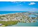Breathtaking aerial view showcasing a coastal community with stunning waterfront homes, sandy beaches, and picturesque water access at 365 La Hacienda Dr, Indian Rocks Beach, FL 33785