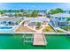 Waterfront home with a private dock, boat lift, and lush landscaping at 365 La Hacienda Dr, Indian Rocks Beach, FL 33785