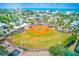 Aerial view showcasing a baseball field with well-maintained grounds and an outdoor court, ready for recreational activities at 365 La Hacienda Dr, Indian Rocks Beach, FL 33785