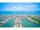 Breathtaking aerial view of waterfront homes along canals leading to the ocean under a beautiful blue sky at 365 La Hacienda Dr, Indian Rocks Beach, FL 33785