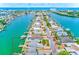 Aerial view of a property, surrounded by canals, featuring a boat dock and swimming pool at 365 La Hacienda Dr, Indian Rocks Beach, FL 33785