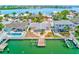 Waterfront home with a dock featuring a large pool with a spa and outdoor entertaining space at 365 La Hacienda Dr, Indian Rocks Beach, FL 33785