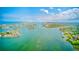 Scenic aerial view of an expansive network of waterways dotted with islands and homes, connecting to the open sea at 365 La Hacienda Dr, Indian Rocks Beach, FL 33785