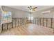 Bright bedroom features light wood floors, and good natural light from two large windows at 365 La Hacienda Dr, Indian Rocks Beach, FL 33785