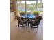 Dining area with tile floors and waterfront views from a large glass window. Table with seating for four at 365 La Hacienda Dr, Indian Rocks Beach, FL 33785