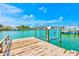 Waterfront dock with a boat lift offering access to beautiful water views at 365 La Hacienda Dr, Indian Rocks Beach, FL 33785