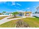 Charming single-story home with well-manicured lawn, covered patio, and inviting walkway at 365 La Hacienda Dr, Indian Rocks Beach, FL 33785