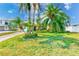 Charming single-story home with a well-maintained lawn, mature palm trees, and a cozy, welcoming curb appeal at 365 La Hacienda Dr, Indian Rocks Beach, FL 33785