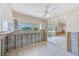 Spacious kitchen area with tile flooring, white cabinets, and a view of the waterfront, ready for remodeling and customization at 365 La Hacienda Dr, Indian Rocks Beach, FL 33785