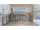 View of unfinished kitchen with white cabinets and window overlooking waterfront; design it to your liking! at 365 La Hacienda Dr, Indian Rocks Beach, FL 33785