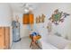 Laundry room with a utility sink, vintage cabinets, water heater and decorative wall hangings at 365 La Hacienda Dr, Indian Rocks Beach, FL 33785