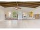 Spacious living room with tiled floors, vaulted wood ceilings and views of the front yard through large windows at 365 La Hacienda Dr, Indian Rocks Beach, FL 33785