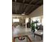 Open-concept living room featuring tile flooring, vaulted ceiling, and a glimpse of the dining area at 365 La Hacienda Dr, Indian Rocks Beach, FL 33785