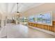 Spacious living room with large windows offering views of the water and access to the outdoor living space at 365 La Hacienda Dr, Indian Rocks Beach, FL 33785