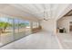 Living room with vaulted ceilings, tile floors, and large sliding glass doors with views of the waterfront at 365 La Hacienda Dr, Indian Rocks Beach, FL 33785