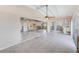 Open-concept living area with tile flooring, featuring access to the kitchen and entryway, awaiting finishing touches at 365 La Hacienda Dr, Indian Rocks Beach, FL 33785