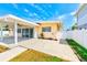 Spacious backyard patio with ceiling fans and plenty of room for entertaining and access to the yard at 365 La Hacienda Dr, Indian Rocks Beach, FL 33785