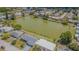 Aerial view showcasing house near a green lake surrounded by a residential neighborhood at 4014 Pleasant Ridge Dr, New Port Richey, FL 34652