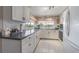 Well-lit kitchen with white cabinets, and a view of the lake at 4014 Pleasant Ridge Dr, New Port Richey, FL 34652