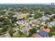 An aerial view shows neighborhood, mature trees, nearby streets, and residential landscape of properties at 4206 W Sevilla St, Tampa, FL 33629