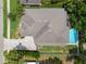 Aerial view of a home showcasing its roof, pool, driveway, and surrounding greenery at 4206 W Sevilla St, Tampa, FL 33629