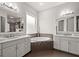 Elegant bathroom featuring double vanities, a large soaking tub, and stylish fixtures at 4206 W Sevilla St, Tampa, FL 33629