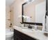 Bathroom features a granite countertop, an oval sink, decorative orchids and tub with tile surround at 4206 W Sevilla St, Tampa, FL 33629
