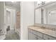 Well-lit bathroom featuring a granite countertop vanity and access to separate shower/tub area at 4206 W Sevilla St, Tampa, FL 33629