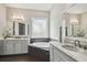 Bright bathroom features a soaking tub and double vanities with marble countertops and modern fixtures at 4206 W Sevilla St, Tampa, FL 33629