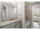Well-lit bathroom features a granite countertop, a mirror, and a combined tub and shower at 4206 W Sevilla St, Tampa, FL 33629