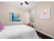 Cozy bedroom with a ceiling fan, white bedding, shuttered windows, and soft natural light at 4206 W Sevilla St, Tampa, FL 33629