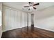 Spacious bedroom featuring hardwood floors, ample closet space, and a ceiling fan at 4206 W Sevilla St, Tampa, FL 33629