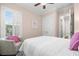 Bright bedroom showcasing white bedding, shuttered window, and access to an ensuite bathroom at 4206 W Sevilla St, Tampa, FL 33629