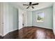 Light-filled bedroom with dark wood floors and a view of the backyard at 4206 W Sevilla St, Tampa, FL 33629